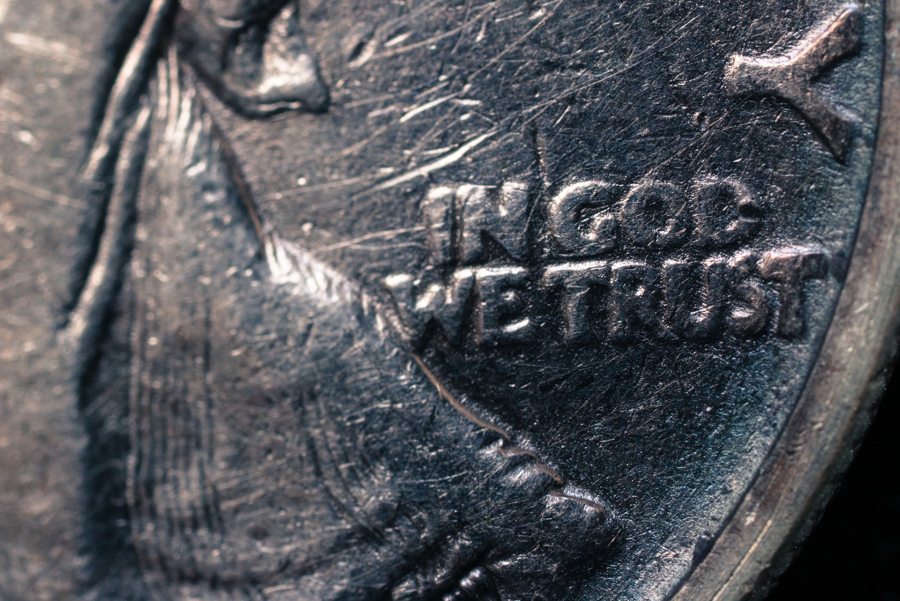 close up of in god we trust on silver coin