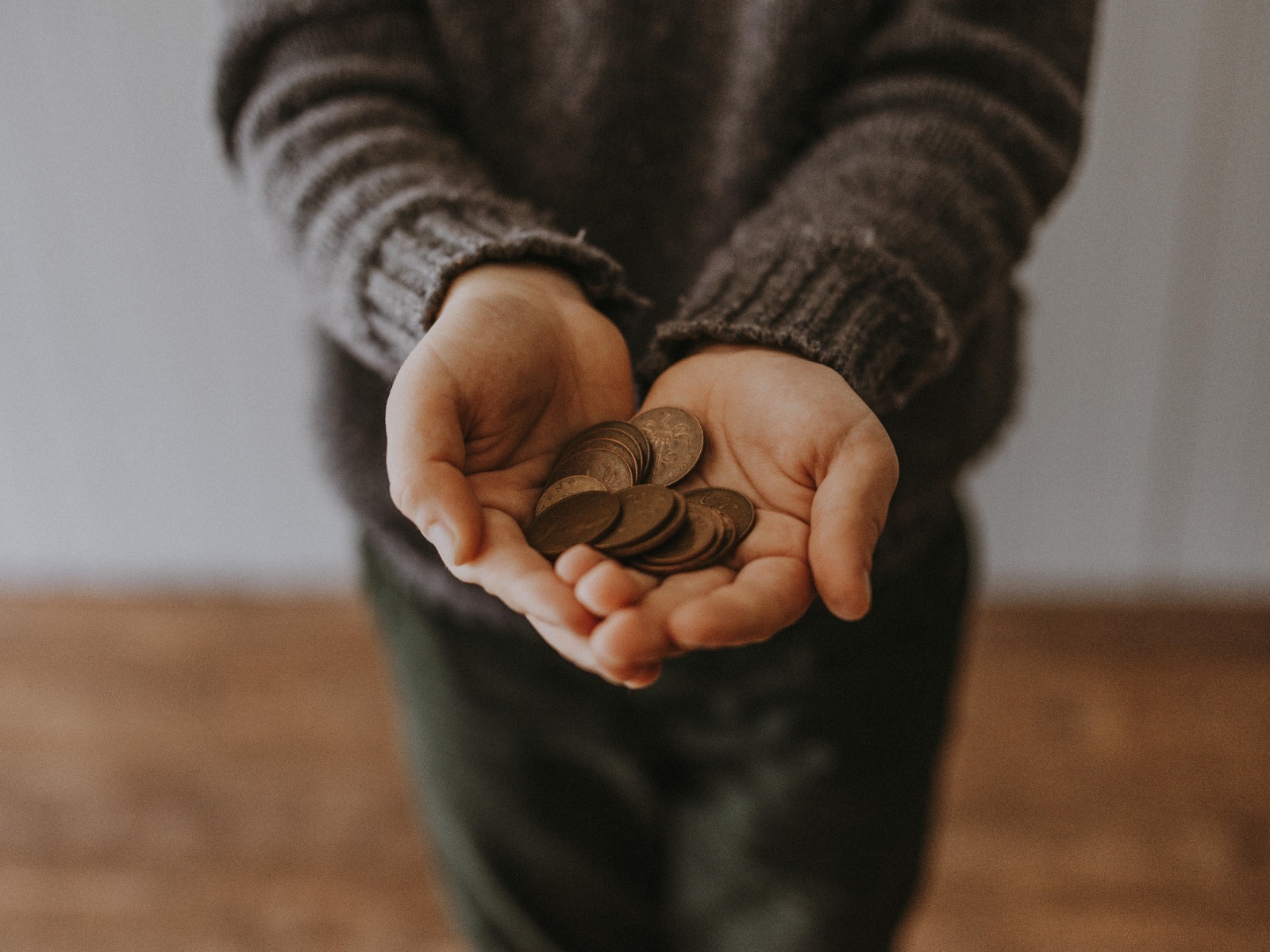 copper pennies in a persons hand